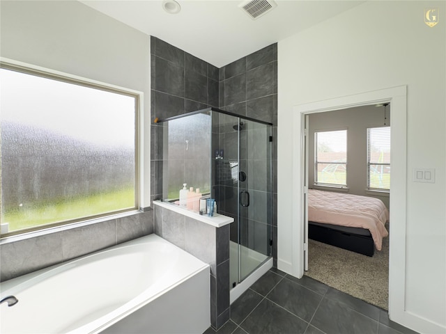 31334 Balsam Hawk Ln, Hockley, TX 77447 - ensuite bathroom with a garden tub, a shower stall, and tile patterned flooring