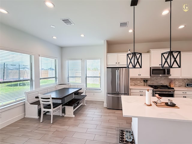 31334 Balsam Hawk Ln, Hockley, TX 77447 - kitchen featuring stainless steel appliances, baseboards, light countertops, decorative backsplash, and recessed lighting