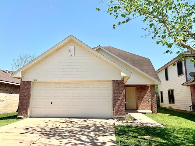 7302 River Pines Dr, Cypress, TX 77433 - view of front facade with brick siding, concrete driveway, a garage, a front yard, and roof with shingles