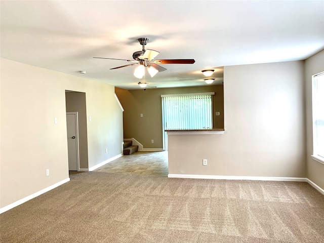 7302 River Pines Dr, Cypress, TX 77433 - carpeted empty room featuring stairway, a ceiling fan, and baseboards