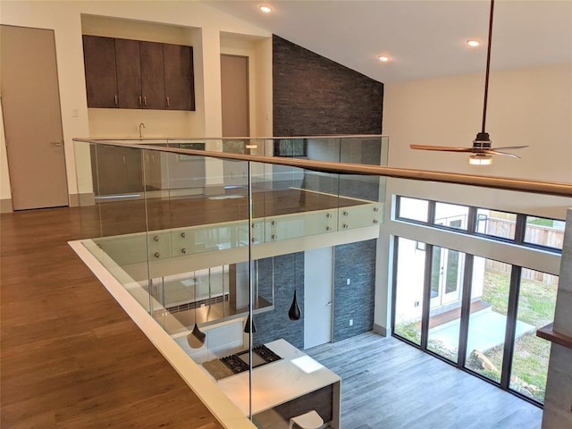 2214 Hewitt Dr, Houston, TX 77018 - stairs featuring wood finished floors, a ceiling fan, recessed lighting, and a high ceiling