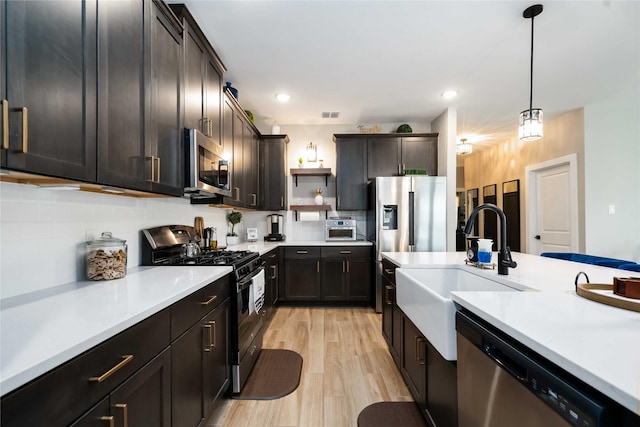 8414 Bay Ridge Cir, Baytown, TX 77523 - kitchen with stainless steel appliances, a sink, light countertops, decorative light fixtures, and recessed lighting