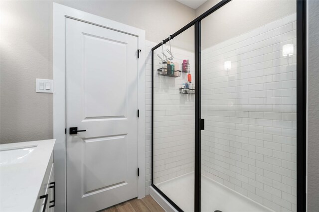 8414 Bay Ridge Cir, Baytown, TX 77523 - bathroom featuring a shower stall, vanity, and wood finished floors