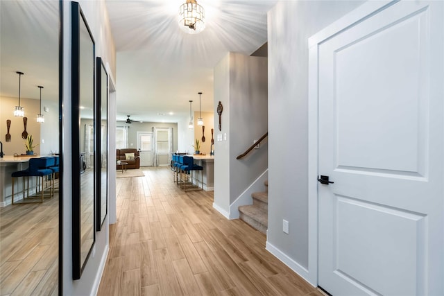 8414 Bay Ridge Cir, Baytown, TX 77523 - corridor with light wood-style floors, baseboards, and stairs