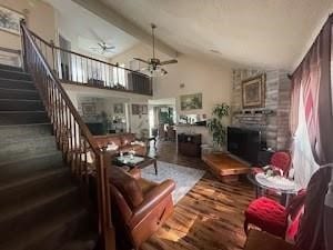 6706 Dinner Creek Ct, Katy, TX 77449 - living area with ceiling fan, wood finished floors, stairway, a fireplace, and high vaulted ceiling