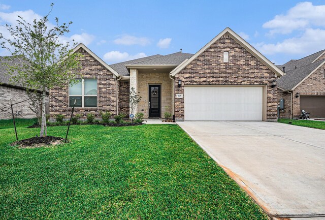 705 Western Fern, League City, TX 77573 - view of front of home with a garage, a front yard, concrete driveway, brick siding, and a shingled roof