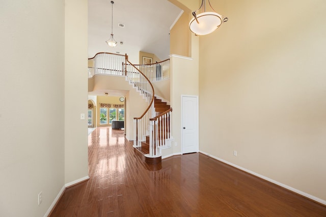 9710 Lansing Meadows Dr, Humble, TX 77396 - foyer entrance featuring a towering ceiling, stairway, and wood finished floors