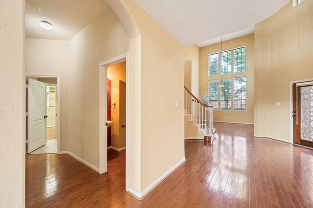 9710 Lansing Meadows Dr, Humble, TX 77396 - foyer with arched walkways, hardwood / wood-style flooring, stairs, and a towering ceiling