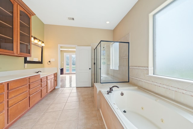9710 Lansing Meadows Dr, Humble, TX 77396 - bathroom featuring a tub with jets, vanity, a stall shower, and tile patterned floors
