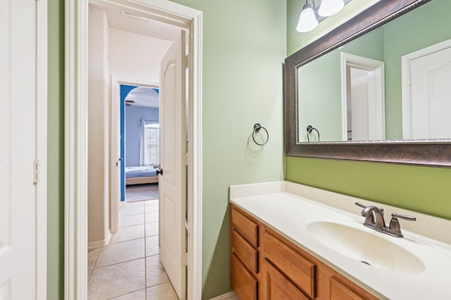 9710 Lansing Meadows Dr, Humble, TX 77396 - bathroom featuring vanity, tile patterned floors, and a textured wall