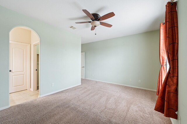 9710 Lansing Meadows Dr, Humble, TX 77396 - carpeted empty room featuring arched walkways and a ceiling fan