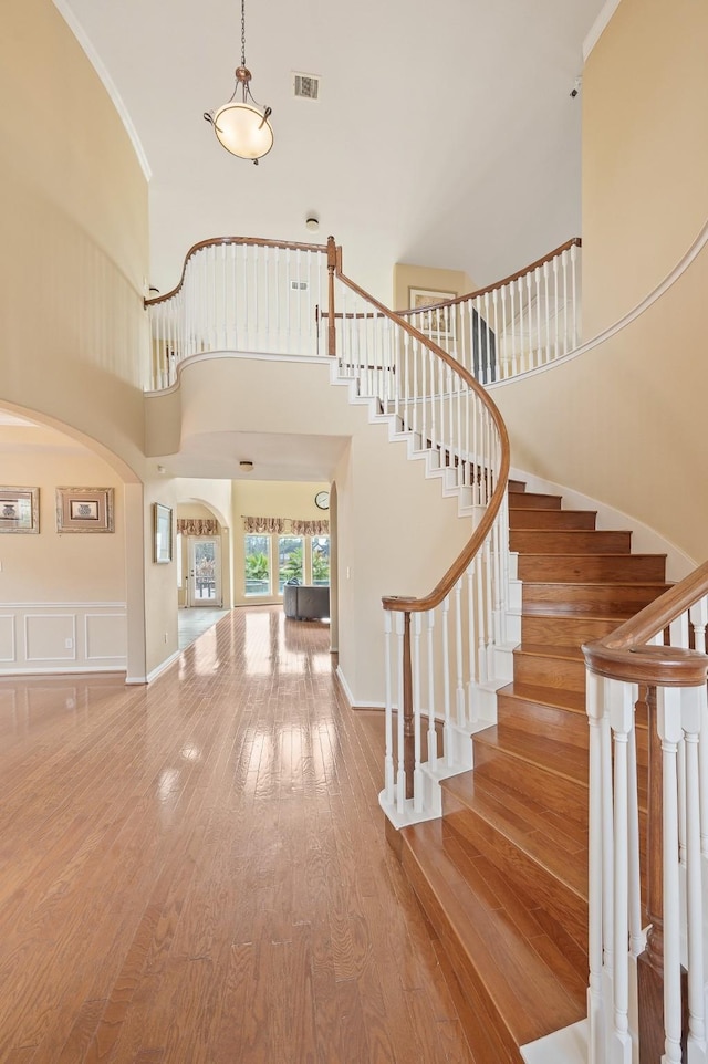 9710 Lansing Meadows Dr, Humble, TX 77396 - foyer with a towering ceiling, arched walkways, wood-type flooring, stairway, and ornamental molding