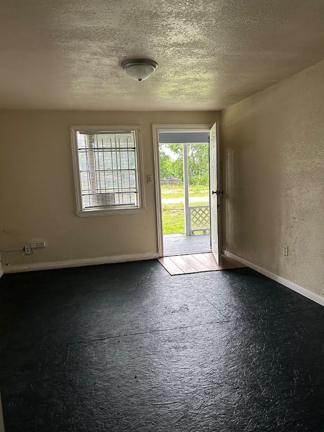 4412 Alvin St, Houston, TX 77051 - empty room with a textured ceiling, baseboards, and a textured wall