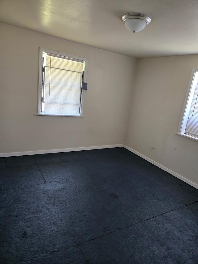4412 Alvin St, Houston, TX 77051 - spare room with plenty of natural light, dark colored carpet, and baseboards