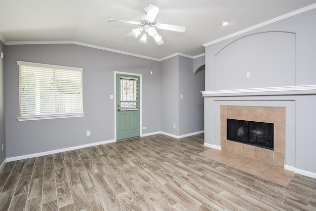 3219 Forest Willow Ln, Houston, TX 77068 - unfurnished living room with a ceiling fan, wood finished floors, lofted ceiling, a tiled fireplace, and baseboards