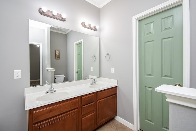 3219 Forest Willow Ln, Houston, TX 77068 - bathroom featuring crown molding, double vanity, toilet, tile patterned flooring, and baseboards