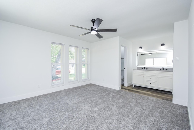 7418 Dew Mist Ln, Houston, TX 77095 - unfurnished bedroom featuring dark colored carpet, baseboards, multiple windows, and connected bathroom