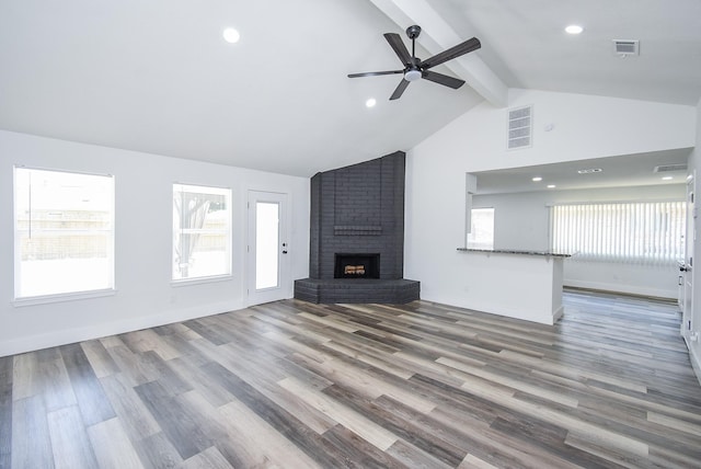 7418 Dew Mist Ln, Houston, TX 77095 - unfurnished living room featuring beam ceiling, a ceiling fan, a brick fireplace, healthy amount of natural light, and recessed lighting