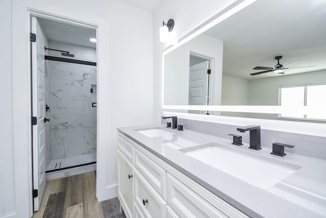7418 Dew Mist Ln, Houston, TX 77095 - bathroom with a marble finish shower, double vanity, a ceiling fan, and wood finished floors