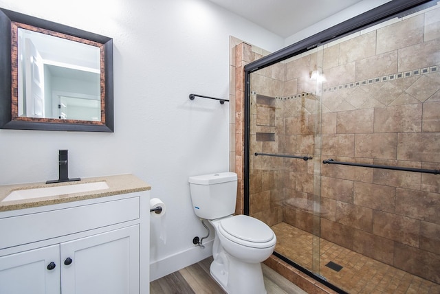 7418 Dew Mist Ln, Houston, TX 77095 - bathroom featuring baseboards, a stall shower, vanity, toilet, and wood finished floors