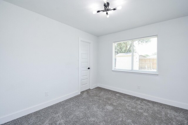 7418 Dew Mist Ln, Houston, TX 77095 - empty room featuring dark colored carpet and baseboards