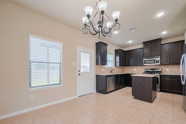 10015 Black Birch Ln, Tomball, TX 77375 - kitchen with appliances with stainless steel finishes, a chandelier, tasteful backsplash, healthy amount of natural light, and recessed lighting