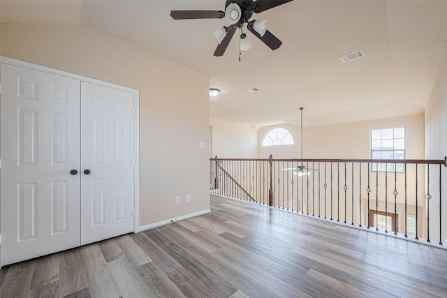10015 Black Birch Ln, Tomball, TX 77375 - unfurnished room with ceiling fan, wood finished floors, vaulted ceiling, and baseboards