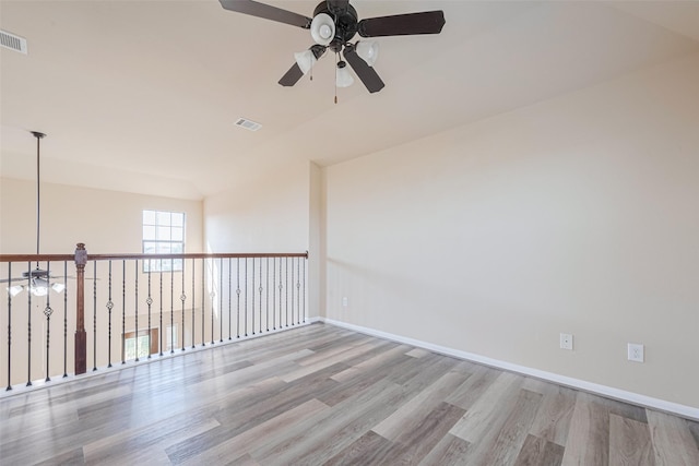 10015 Black Birch Ln, Tomball, TX 77375 - spare room featuring a ceiling fan, wood finished floors, and baseboards
