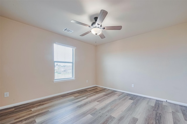 10015 Black Birch Ln, Tomball, TX 77375 - unfurnished room featuring light wood-style floors, ceiling fan, and baseboards