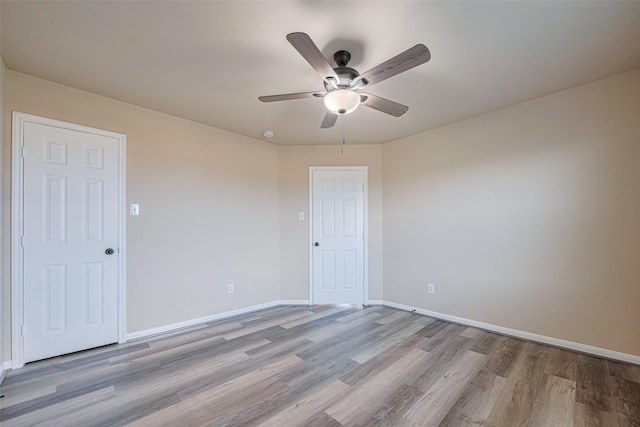 10015 Black Birch Ln, Tomball, TX 77375 - unfurnished room with wood finished floors, ceiling fan, and baseboards