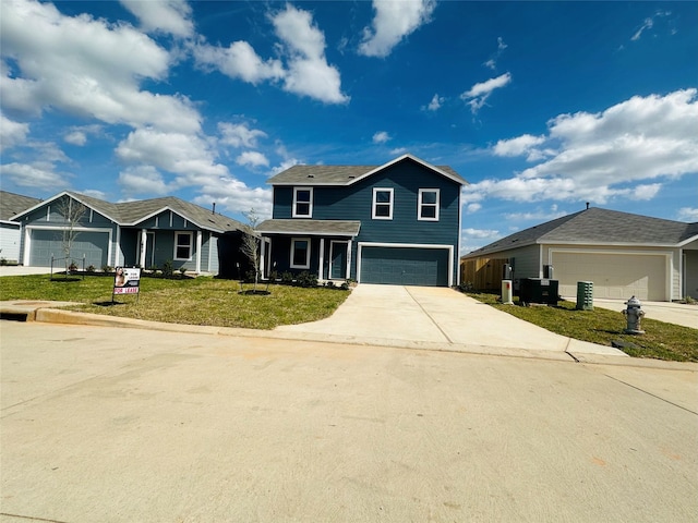 16477 Blossom Grove Dr, Conroe, TX 77303 - traditional home with concrete driveway, a front yard, and a garage