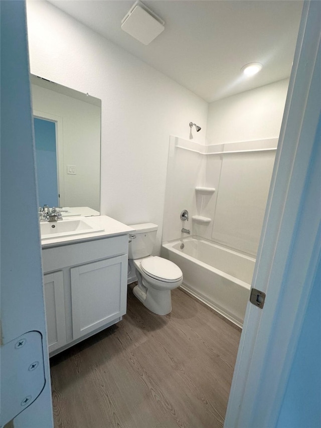 16477 Blossom Grove Dr, Conroe, TX 77303 - full bathroom featuring wood finished floors, vanity, toilet, and bathing tub / shower combination