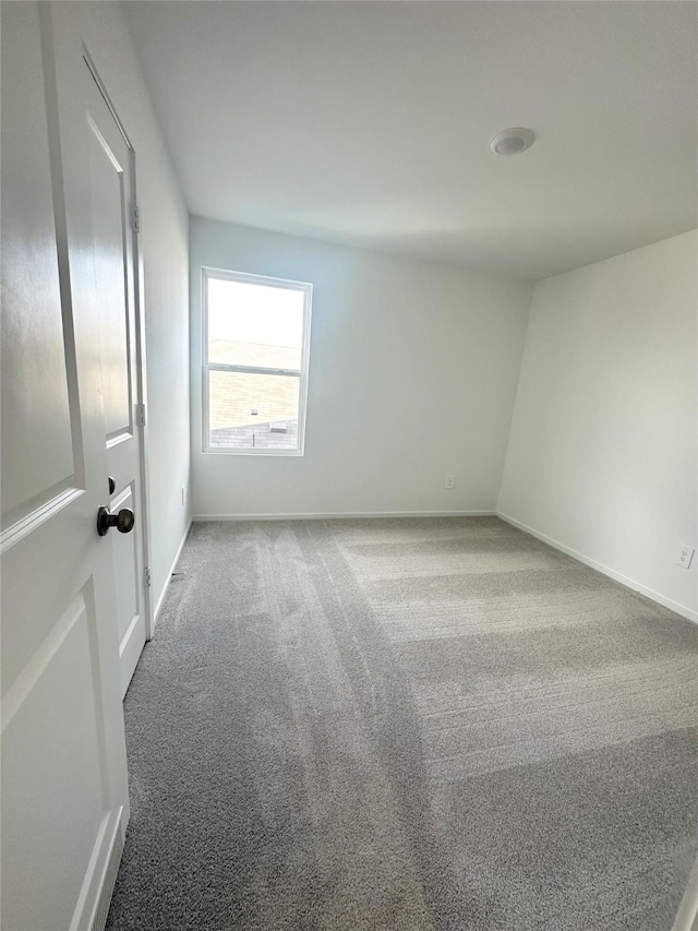 16477 Blossom Grove Dr, Conroe, TX 77303 - spare room featuring carpet floors and baseboards