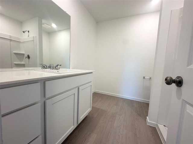16477 Blossom Grove Dr, Conroe, TX 77303 - bathroom featuring wood finished floors, vanity, and baseboards