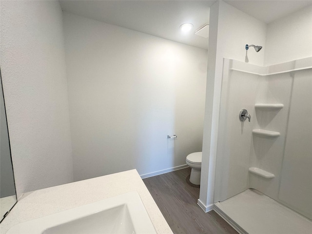 16477 Blossom Grove Dr, Conroe, TX 77303 - full bath featuring toilet, wood finished floors, a shower, baseboards, and vanity