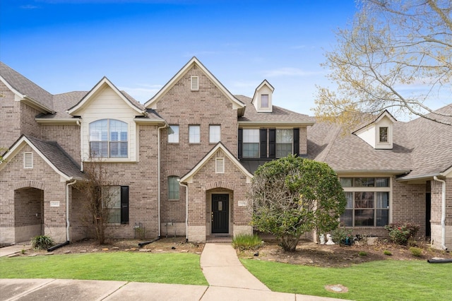 2411 Clippers Sq, Houston, TX 77058 - view of front of home with brick siding, a front lawn, and roof with shingles
