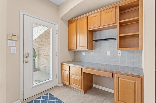 2411 Clippers Sq, Houston, TX 77058 - kitchen with open shelves, light tile patterned floors, tasteful backsplash, and baseboards