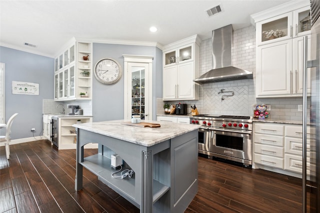 5219 Camp Creek Rd, Baytown, TX 77523 - kitchen featuring open shelves, double oven range, wall chimney range hood, crown molding, and decorative backsplash