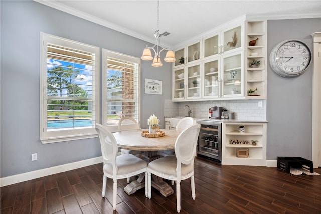 5219 Camp Creek Rd, Baytown, TX 77523 - dining area featuring wine cooler, dark wood-type flooring, baseboards, crown molding, and healthy amount of natural light