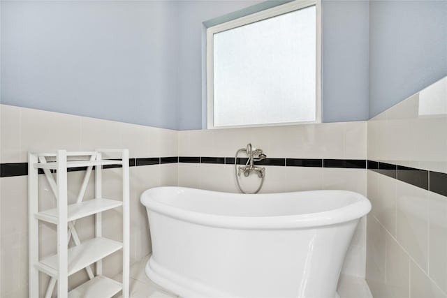 5219 Camp Creek Rd, Baytown, TX 77523 - full bathroom featuring tile walls and a freestanding tub