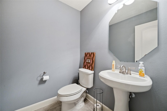 5219 Camp Creek Rd, Baytown, TX 77523 - bathroom featuring toilet, tile patterned flooring, and baseboards