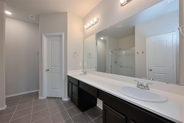 2535 Sandbar Shark Ct, Katy, TX 77449 - bathroom with double vanity, a shower stall, tile patterned flooring, baseboards, and recessed lighting