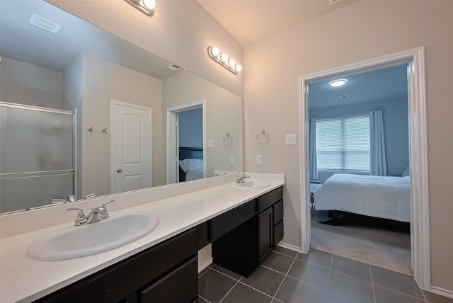 2535 Sandbar Shark Ct, Katy, TX 77449 - bathroom with ensuite bath, double vanity, tile patterned flooring, baseboards, and a shower with door