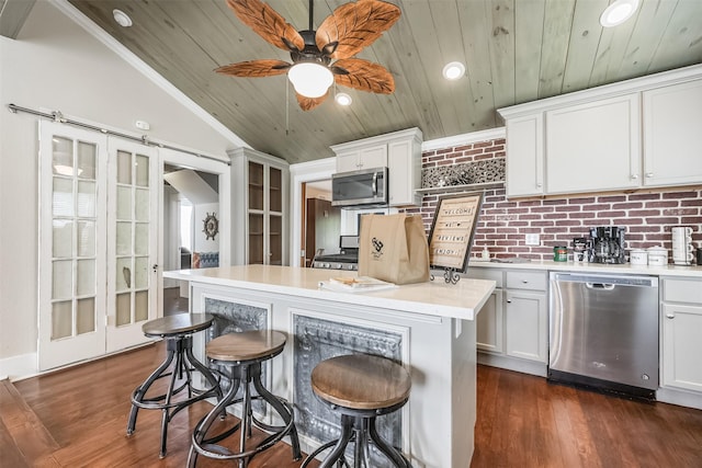 1414 Mechanic St, Galveston, TX 77550 - kitchen with stainless steel appliances, wood ceiling, a kitchen bar, lofted ceiling, and light countertops