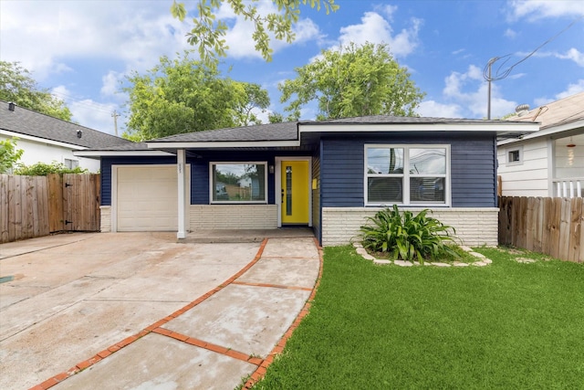 905 E 39th St, Houston, TX 77022 - view of front of property featuring a garage, concrete driveway, brick siding, and a shingled roof