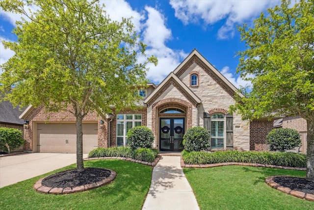 2314 Umber Oaks Ln, Brookshire, TX 77423 - view of front of home with french doors, brick siding, driveway, and a front yard