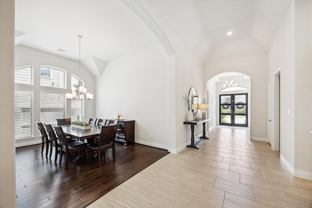 2314 Umber Oaks Ln, Brookshire, TX 77423 - dining space featuring a chandelier, plenty of natural light, arched walkways, and high vaulted ceiling