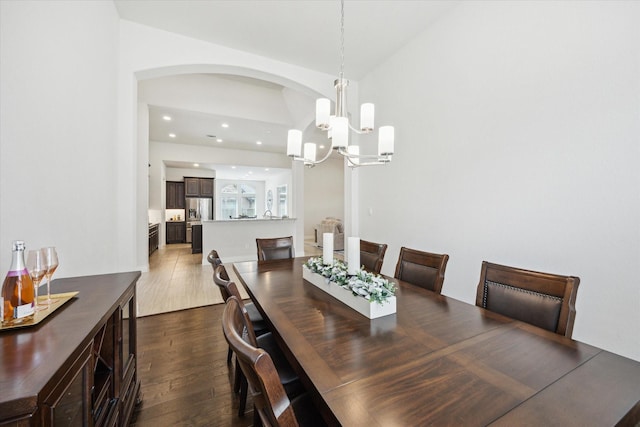 2314 Umber Oaks Ln, Brookshire, TX 77423 - dining room featuring dark wood finished floors, a chandelier, arched walkways, and recessed lighting