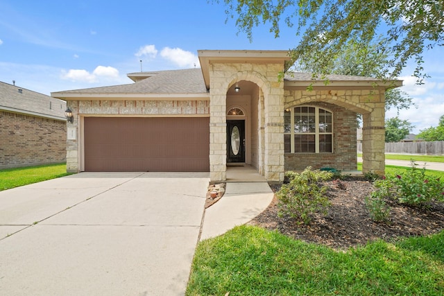 8727 Debbie Terrace Dr, Cypress, TX 77433 - mediterranean / spanish-style home with an attached garage, concrete driveway, stone siding, and a shingled roof