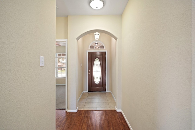 8727 Debbie Terrace Dr, Cypress, TX 77433 - entryway featuring arched walkways, a textured wall, wood finished floors, and baseboards